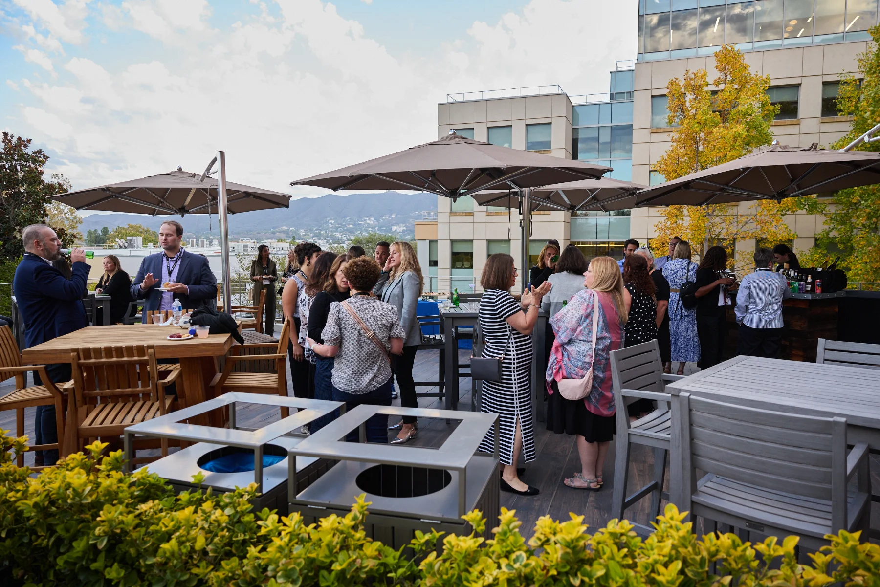 PQMD members talking on a rooftop terrace